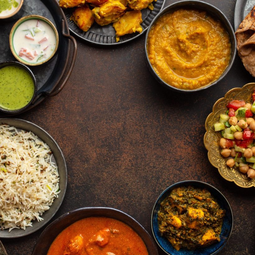 variety-indian-food-different-dishes-snacks-dark-rustic-background-pilaf-butter-chicken-curry-rice-palak-paneer-chicken-tikka-dal-soup-naan-bread-assortment-chutney-copy-space